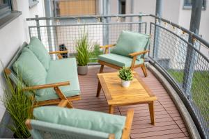 ein Balkon mit zwei Stühlen und einem Tisch in der Unterkunft Luma-Living Apartments in Dresden