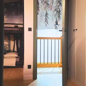 an open door to a balcony with a view of a bed at Zakontek Lubkowa in Lubkowo +34 photos