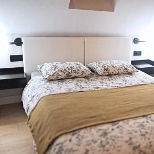 a bedroom with a bed with two pillows on it at Zakontek Lubkowa in Lubkowo