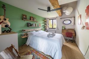 a bedroom with a bed in a room with green walls at La Rose du Petit Bois in Saint-Didier-au-Mont-dʼOr +30 photos