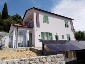 a house with a solar panel in front of it at Monolocale in campagna in Camporosso