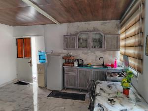 a kitchen with a white refrigerator and a sink at شقه بغرفه وصاله وبلكونه بدون شراكة in Amman