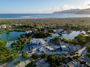 an aerial view of a villa with a lake at Designer Villa in Comporta in Troia