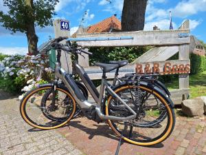 a bike parked in front of a bar cafe sign at Tinyhouse met Hot Tub en ruime privé tuin in Gees