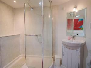 ein Badezimmer mit Dusche und Waschbecken in der Unterkunft Dragon Cottage in Axminster + 24 Fotos