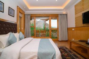 a bedroom with a large bed and a window at The Countryside Villa Ladakh in Shey +2 photos
