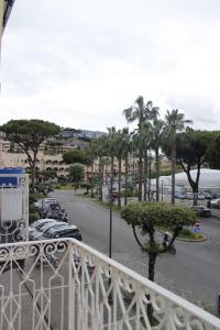 a balcony with a view of a street and palm trees at B&B Anema'e Core in Gaeta