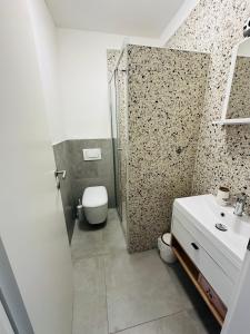 a bathroom with a shower and a toilet and a sink at app Manja1 in Novigrad Istria +9 photos