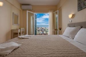 a bedroom with a bed with a view of the ocean at Julia Hotel in Fourka