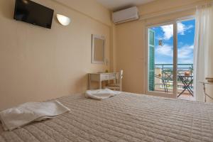 a bedroom with a bed and a window with a view at Julia Hotel in Fourka