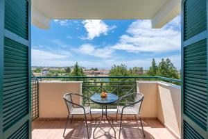 a balcony with a table and chairs with a view at Julia Hotel in Fourka