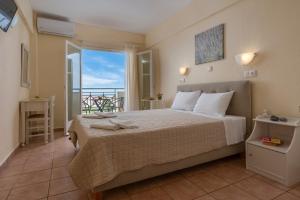 a bedroom with a bed with a view of the ocean at Julia Hotel in Fourka