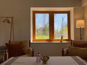 a window in a room with a table and a table sidx sidx sidx at Bazalt Tigris Vendégház in Zalahaláp
