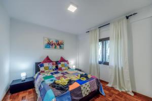 カニコにあるApartamento Vista Oceanoのベッドルーム(カラフルなキルトのベッド付)