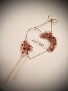a heart shaped sign with flowers on a wall at Casa AnnaPaola Luxury in Chioggia