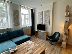 a living room with a couch and a television at Like-a House Centrum in Płock
