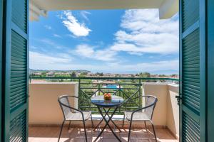 a balcony with a table and chairs and a view at Julia Hotel in Fourka