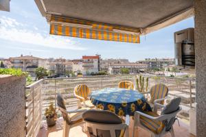 a patio with a table and chairs on a balcony at Imperatore Apartment in Cunit