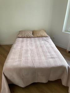 a bedroom with a bed with a white bedspread at La Savoureuse in Belfort
