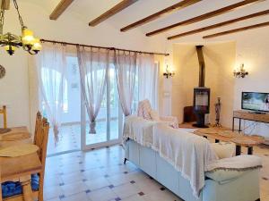 a living room with a couch and a table and a television at Holiday Home Marina 8 in Jávea