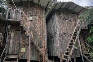 an old wooden building with stairs on the side of it at Bayrams Tree Houses in Olympos