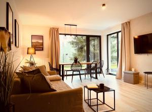 a living room with a couch and a table at Daj Sobie Spokój - WIDOK 800mnpm OGRÓDEK in Szklarska Poręba