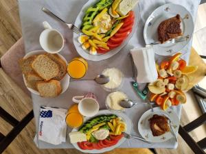 a table topped with plates of food and drinks at Rooms by Lion in Krujë