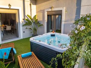 a jacuzzi tub in the backyard of a house at Casa Dionysia - New Lux 2Br with Jacuzzi near Maleme Beach in Maleme