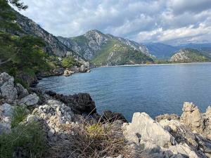 a large body of water with mountains in the background at Bayrams Tree Houses in Olympos