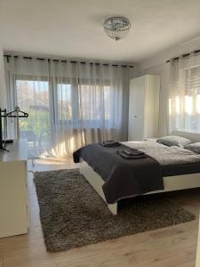 a bedroom with a bed and a large window at Stilvolles Apartment nahe Therme und PreZero Arena in Sinsheim +50 photos