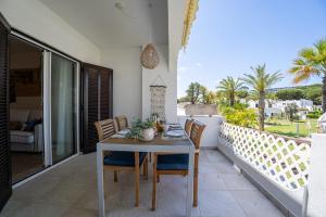 a table and chairs on the balcony of a house at Luxury Beach House Apartment - Golf & Tennis Court & Pool View in Albufeira