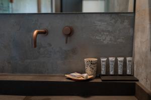 a counter with a cup and a tray with a coffee mug at Doria Luxury Boutique Hotel in Dishon +80 photos