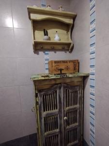 a room with a wooden cabinet and a shelf at Casa Encantada in Aguas Verdes +28 photos