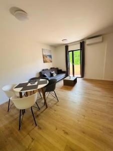 a living room with a table and chairs and a couch at app Manja1 in Novigrad Istria