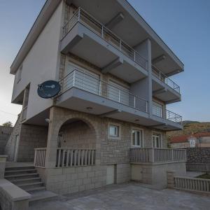 a building with a staircase on the side of it at VILA Ivanica BiH 12 km od Dubrovnika in Ravno