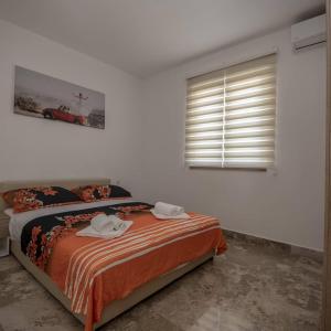 a bedroom with a bed with two towels on it at VILA Ivanica BiH 12 km od Dubrovnika in Ravno