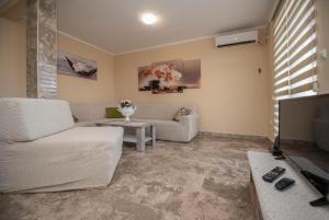 a living room with a couch and a tv at VILA Ivanica BiH 12 km od Dubrovnika in Ravno
