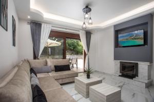 a living room with a couch and a fireplace at Oasis Luxury Villa in Rhodes Town