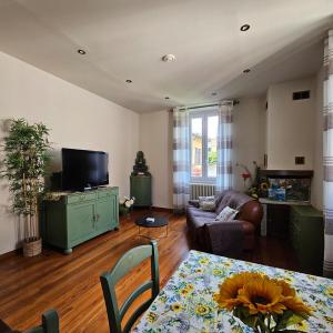 a living room with a couch and a table at Il Girasole Holiday Home in Porto Ceresio