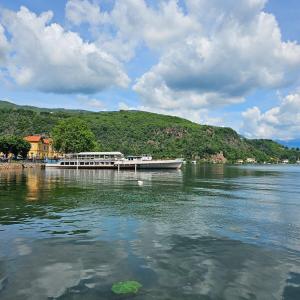 a boat is docked at a dock on the water at Il Girasole Holiday Home in Porto Ceresio