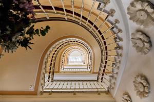 a spiral staircase in a building with a window at Cristine Bedfor Malaga Boutique Hotel in Málaga