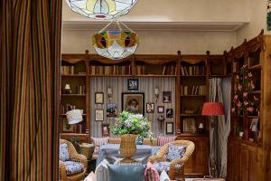 a living room with a table and chairs at Cristine Bedfor Malaga Boutique Hotel in Málaga