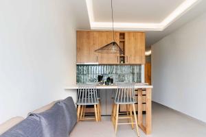 a kitchen with a counter and stools in a room at The View Suites Preveza in Preveza