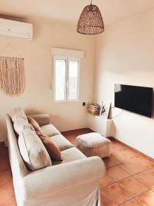 a living room with a couch and a flat screen tv at Rooftop 24 in Calpe