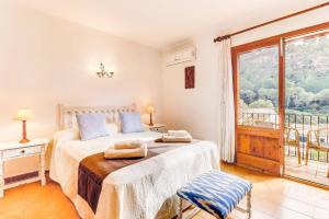 a bedroom with a bed and a large window at Villa Can March by Villa Plus in Cala de Sant Vicenc +25 photos