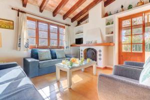 a living room with couches and a fireplace at Villa Can March by Villa Plus in Cala de Sant Vicenc