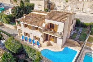 an aerial view of a house with a swimming pool at Villa Can March by Villa Plus in Cala de Sant Vicenc