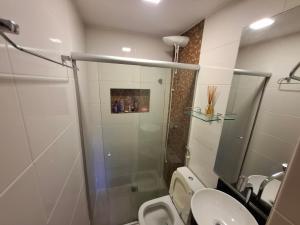 a bathroom with a shower and a toilet and a sink at Asa Norte - Suíte Premium - Conforto e praticidade in Brasília +29 photos