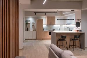 a kitchen and living room with a couch and a counter at Never Space Up Apartment Piraeus Center Port Stay in Piraeus