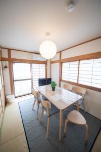 a dining room with a table and chairs at Style Labお花茶屋2 in Tokyo